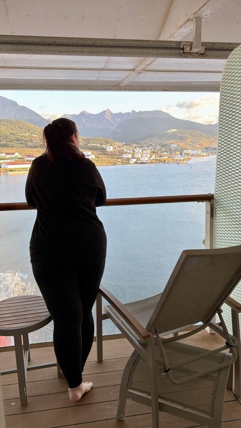 hannah on a cruise balcony overlooking Ushuaia, argentina